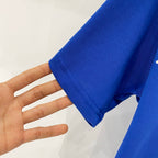 Blue cotton T-shirt fabric sleeve close-up with visible knit texture