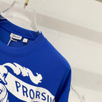 Blue T-shirt sleeve and shoulder with partial PRORSUM graphic print