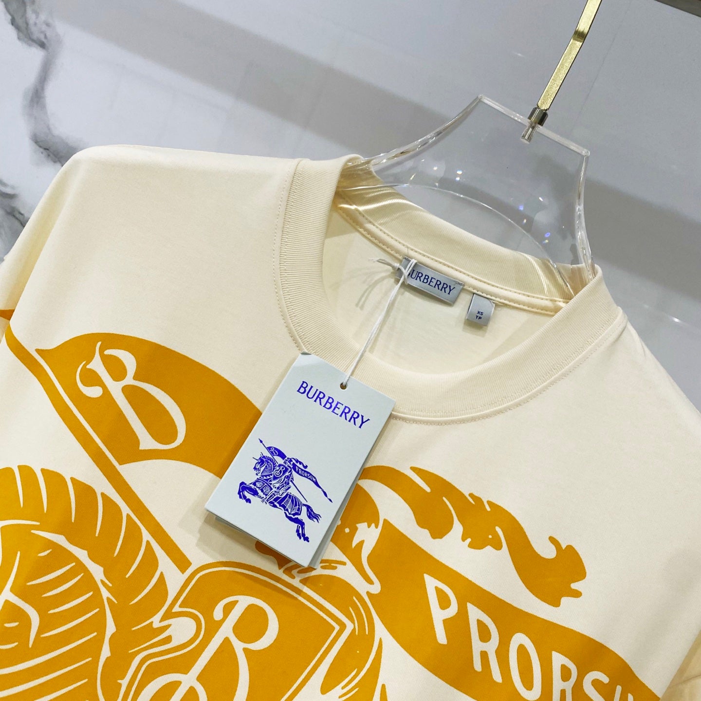 Burberry short-sleeve T-shirt with cream base, orange graphic and small hang tag