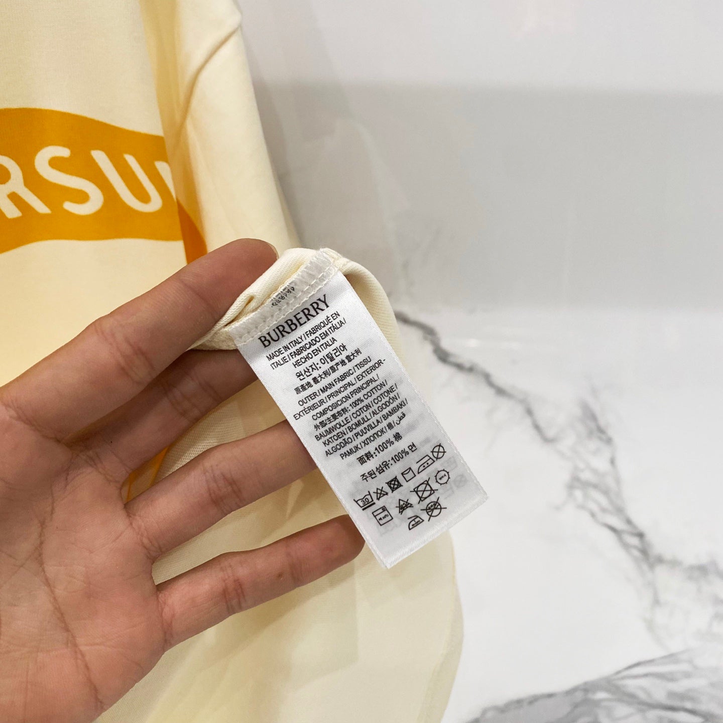 Burberry short-sleeve T-shirt care label on cream fabric