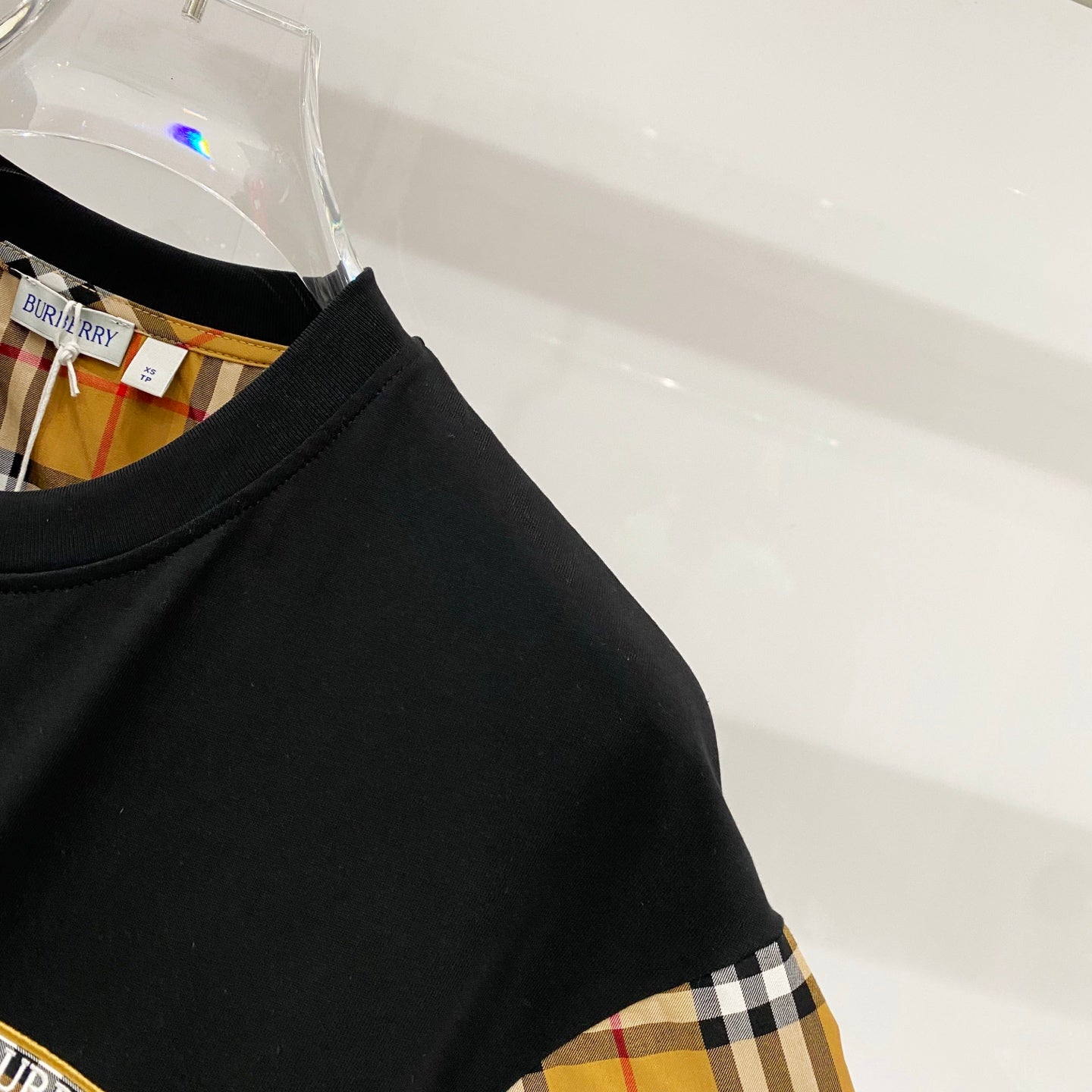 Black T-shirt front with Burberry check sleeve panel detail