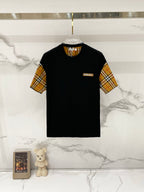 Black short-sleeve T-shirt with tan, red, and navy check sleeves