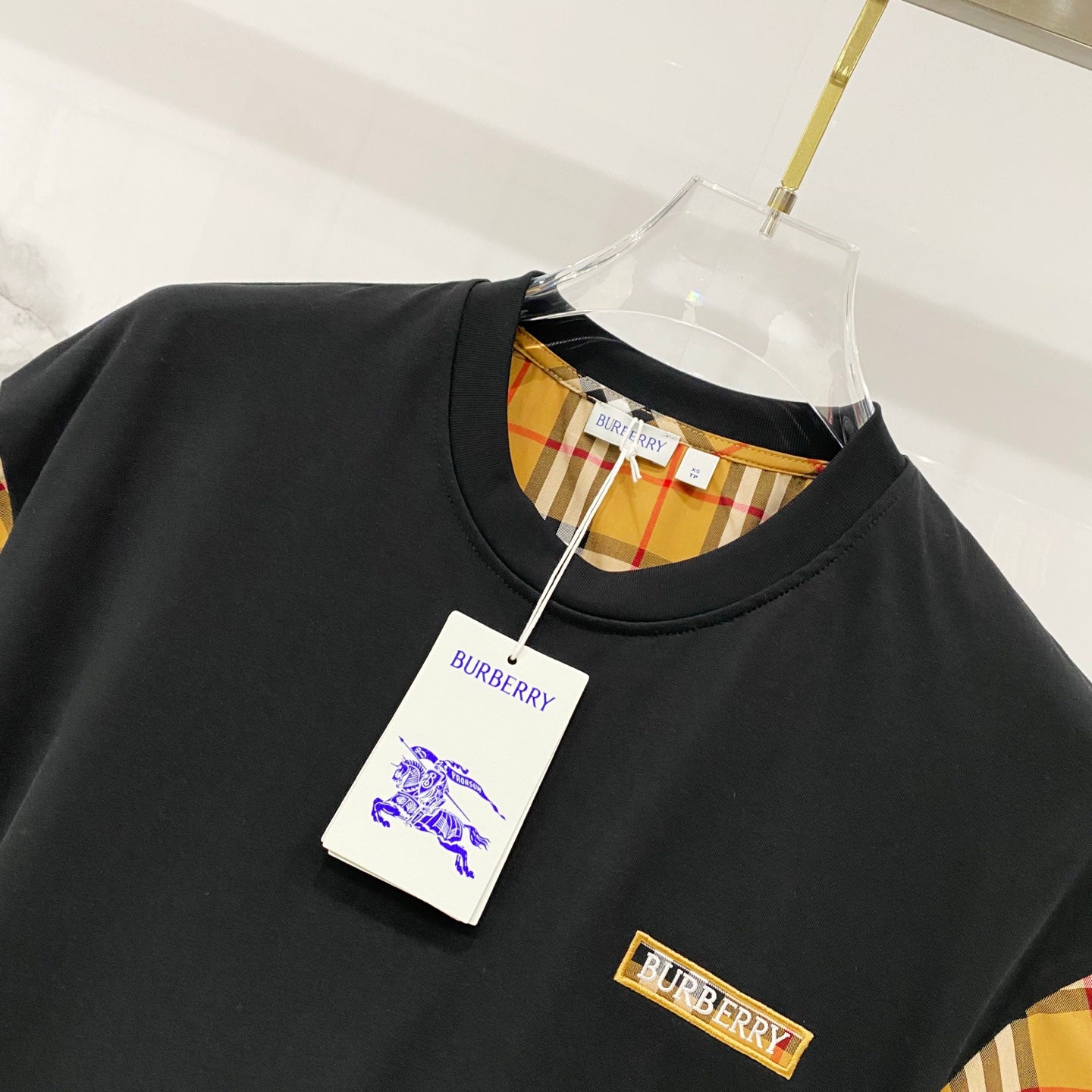 Black crewneck T-shirt with Burberry check trim and logo patch on chest