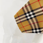 Burberry plaid check sleeve cuff with tan, black, and red tones