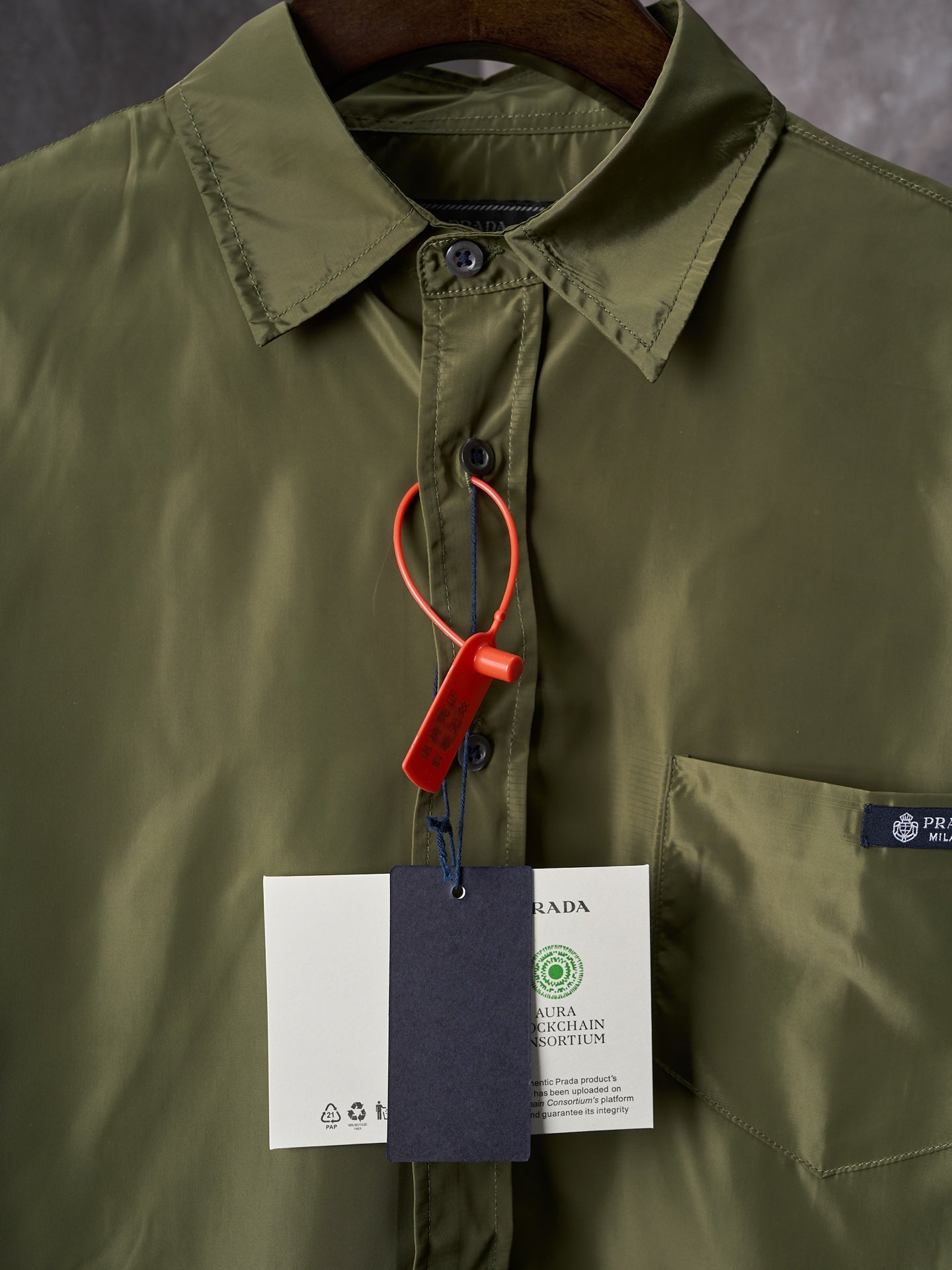 Olive Prada button-up shirt collar close-up with hanging size tags