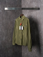 Olive Prada button-up shirt front view with chest pocket and hanging tags