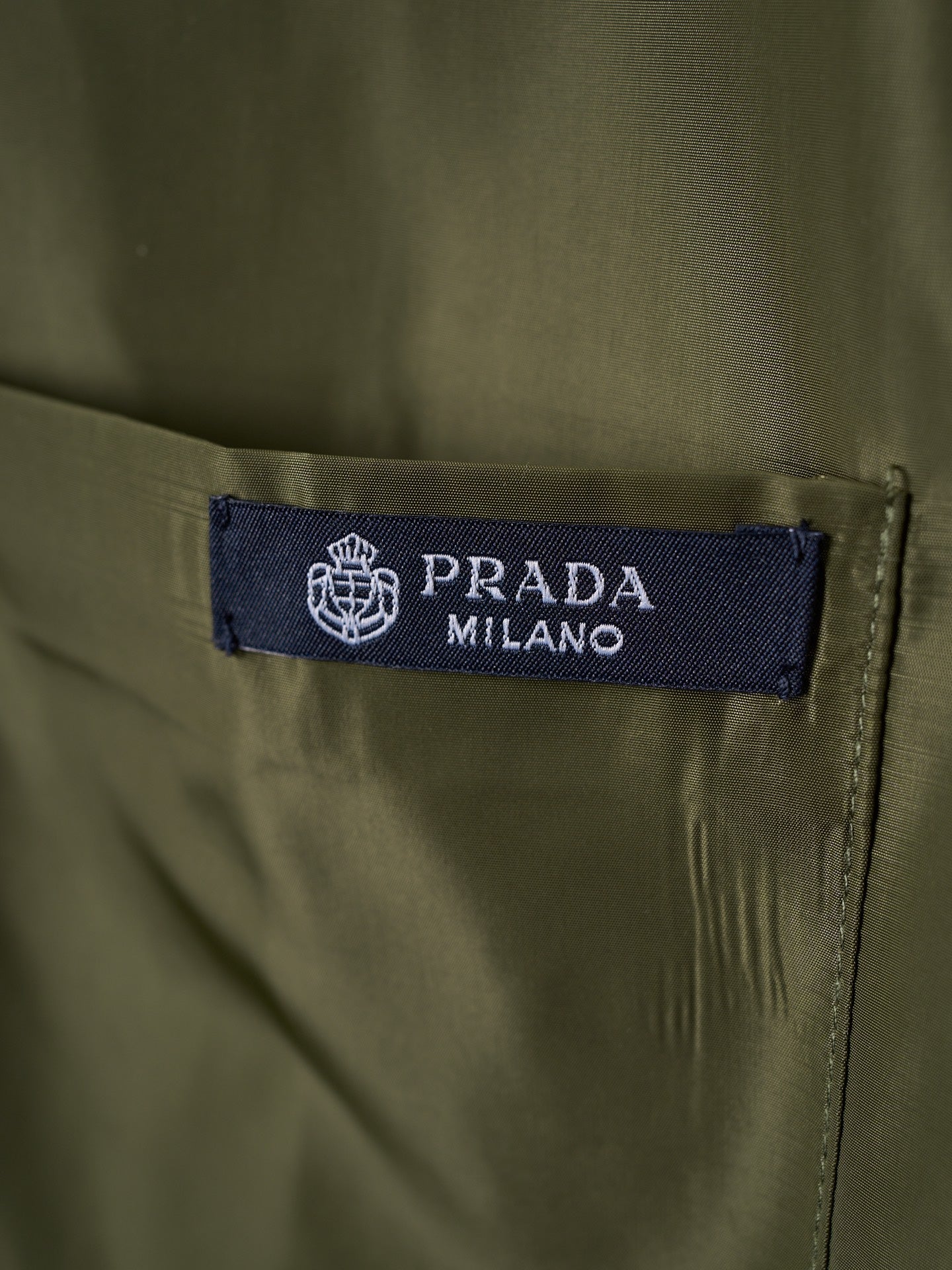 Prada Milano interior neck label on olive button-up shirt