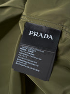 Prada garment care label on olive button-up shirt neck area
