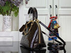 Louis Vuitton bag with structured dome shape, dark monogram finish, top handles and crossbody strap.