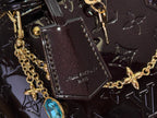 Louis Vuitton bag detail: gold chain hardware over dark monogram canvas with stitched inner patch.