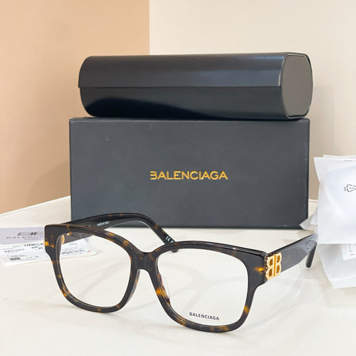 Balenciaga eyeglasses with tortoiseshell accents and clear lenses, gold BB logo detail