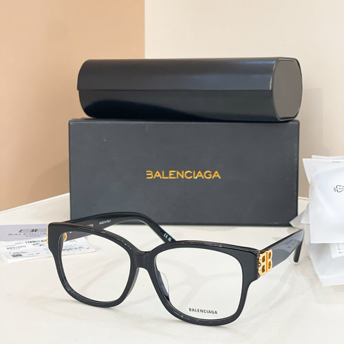 Balenciaga eyeglasses with dark frame and clear lenses, with gold BB logo temples