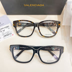 Pair of Balenciaga eyeglasses with clear lenses, one dark frame and one tortoiseshell