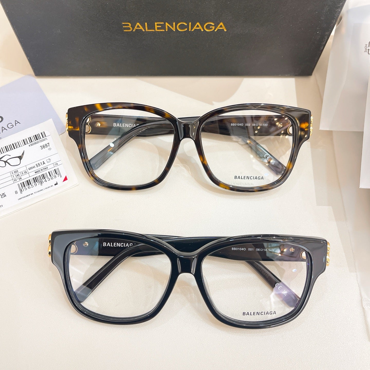 Pair of Balenciaga eyeglasses with clear lenses, one dark frame and one tortoiseshell