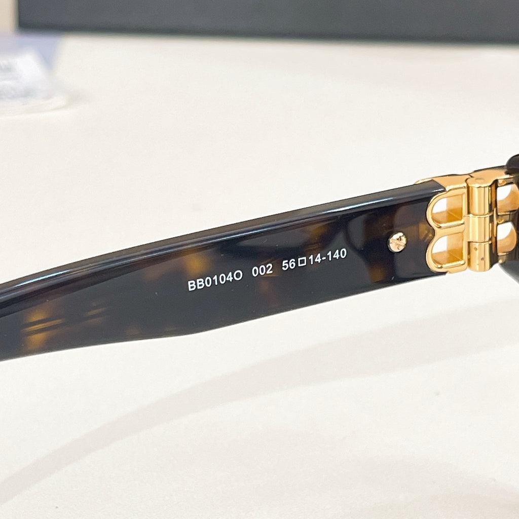 Balenciaga eyeglass front bar showing embossed markings and gold hinge hardware