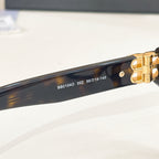 Balenciaga eyeglass front bar showing embossed markings and gold hinge hardware