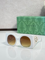 Gucci sunglasses with white square frames and warm brown tinted lenses, silver logo detail