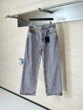 Light blue denim pants on hanger with front button and two front pockets