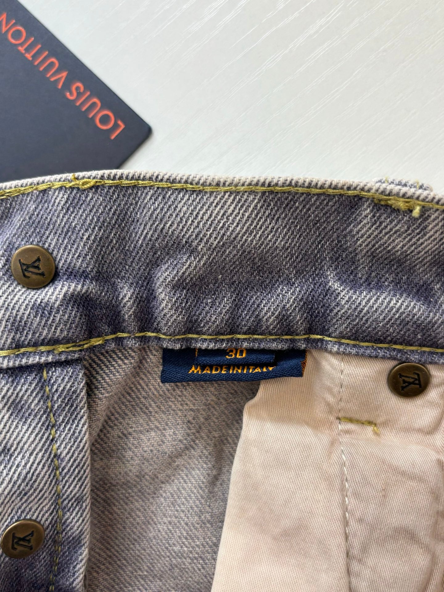 Denim pants waistband with Louis Vuitton label, buttoned fly and gold topstitching