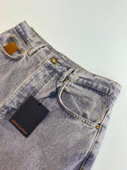 Light blue denim pants detail view with waistband, belt loops, and front button