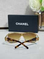 Sunglasses with golden lenses, gold-tone frame, embellished temple hardware