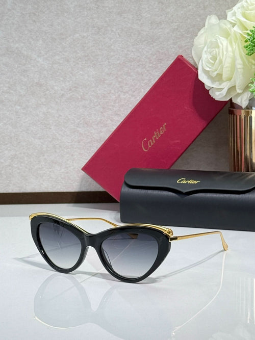 Black cat-eye sunglasses with gold-tone temples and dark tinted lenses