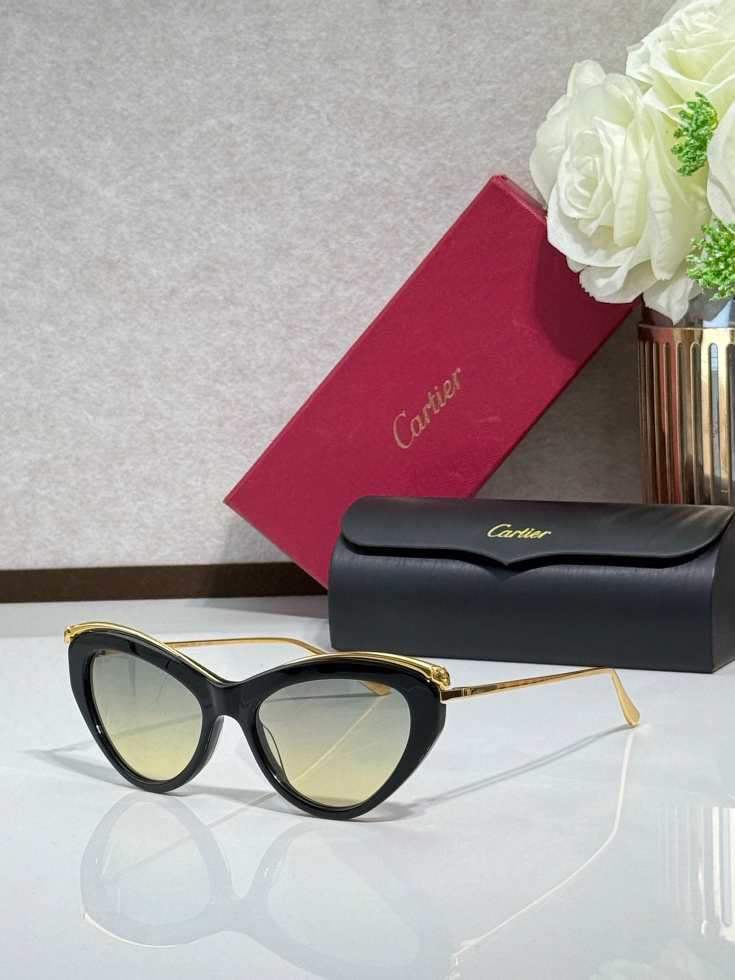 Black oversized sunglasses with gold-tone temples and light-reflective lenses