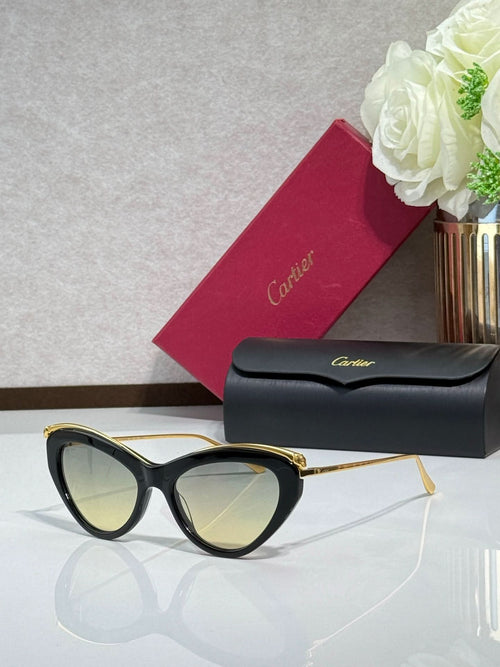 Black oversized sunglasses with gold-tone temples and light-reflective lenses