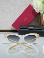White sunglasses with gold-tone rims and dark tinted lenses