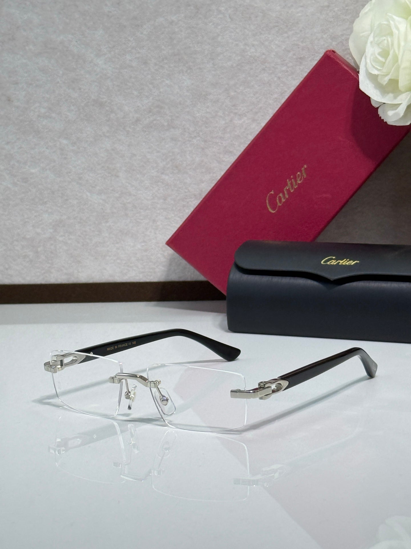Gold-trim eyeglasses with clear lenses and dark temples