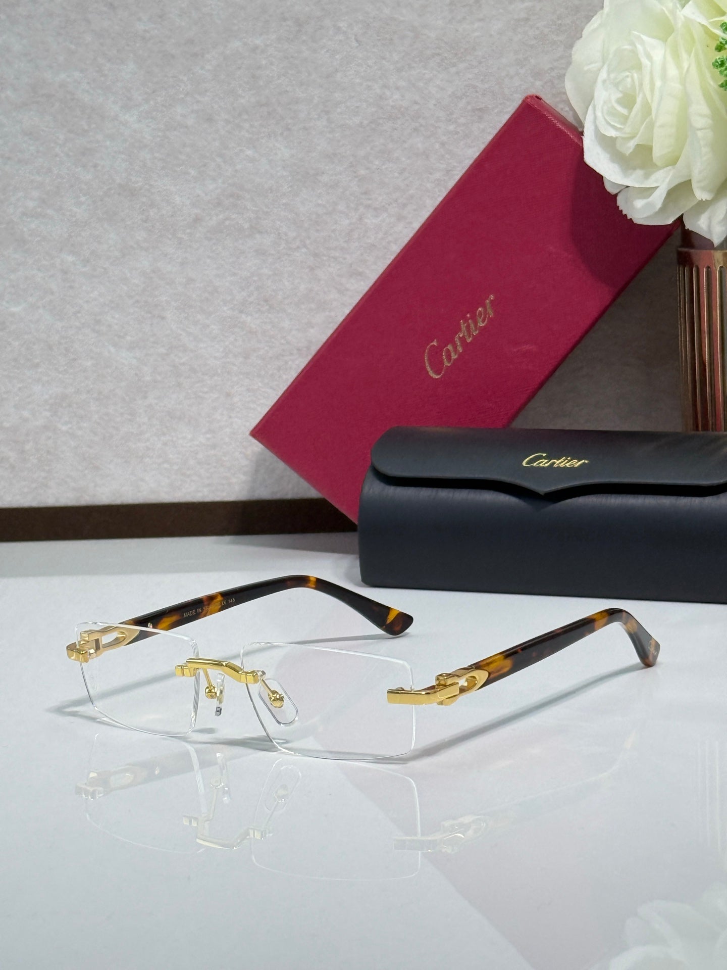 Gold and tortoise acetate eyeglasses with clear lenses, side view