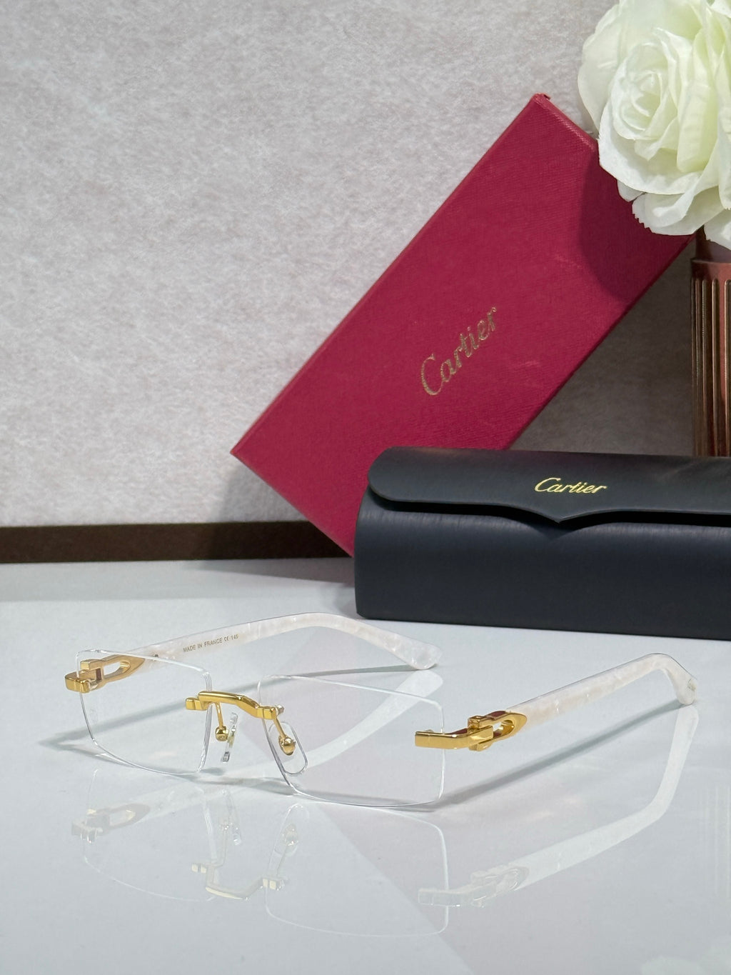 Gold-rimmed eyeglasses with clear lenses and dark temples