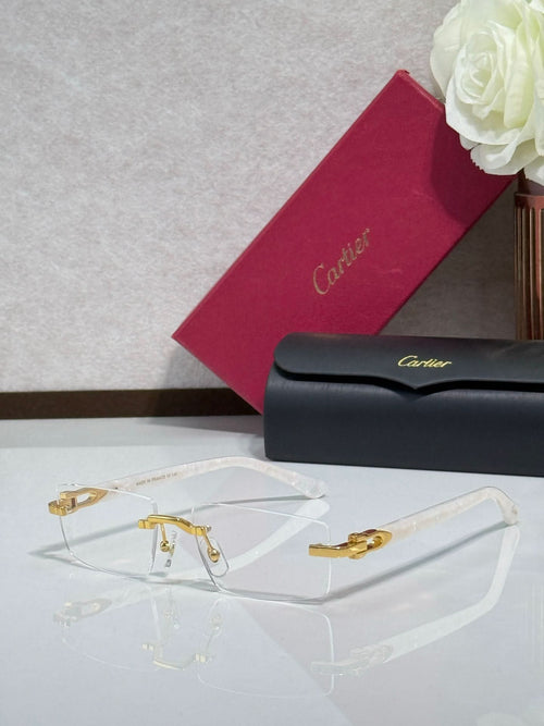 Gold-rimmed eyeglasses with clear lenses and dark temples