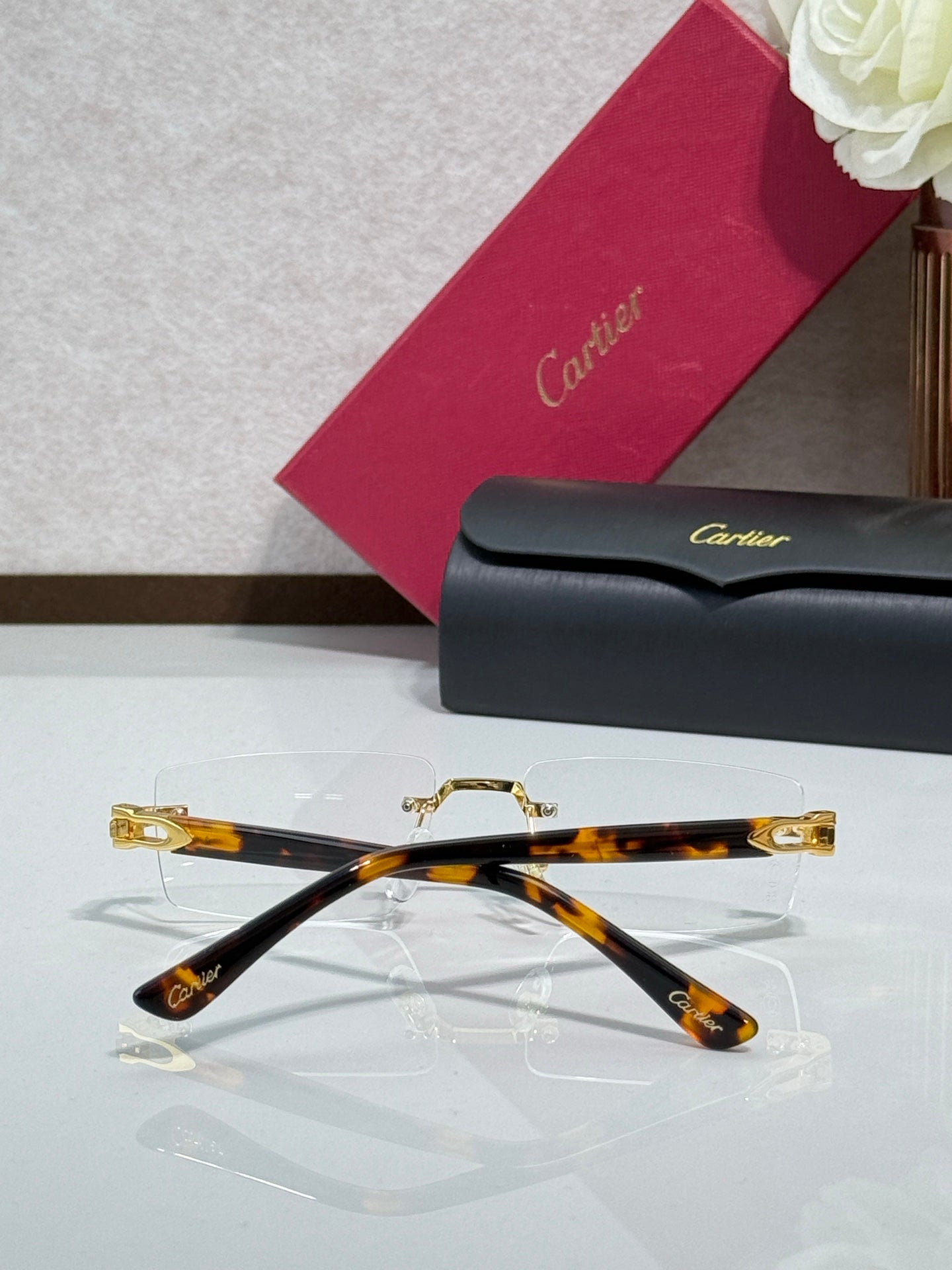 Tortoise and gold eyeglasses with clear lenses, top view