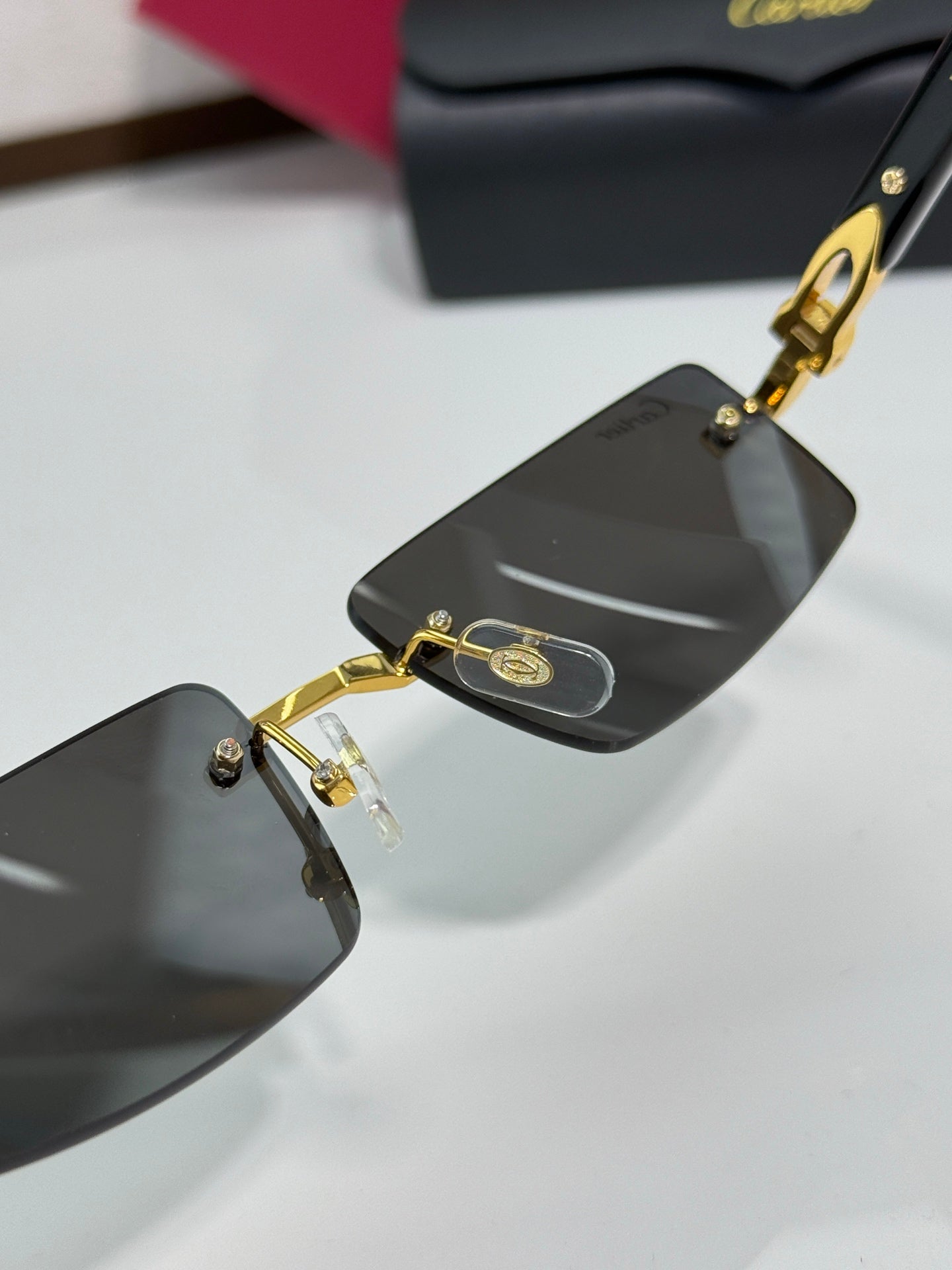 Cartier eyeglasses close-up with dark lenses and gold-tone hinge and frame hardware