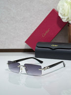 Cartier eyeglasses with dark frames and silver-tone hinges, featuring tinted lenses