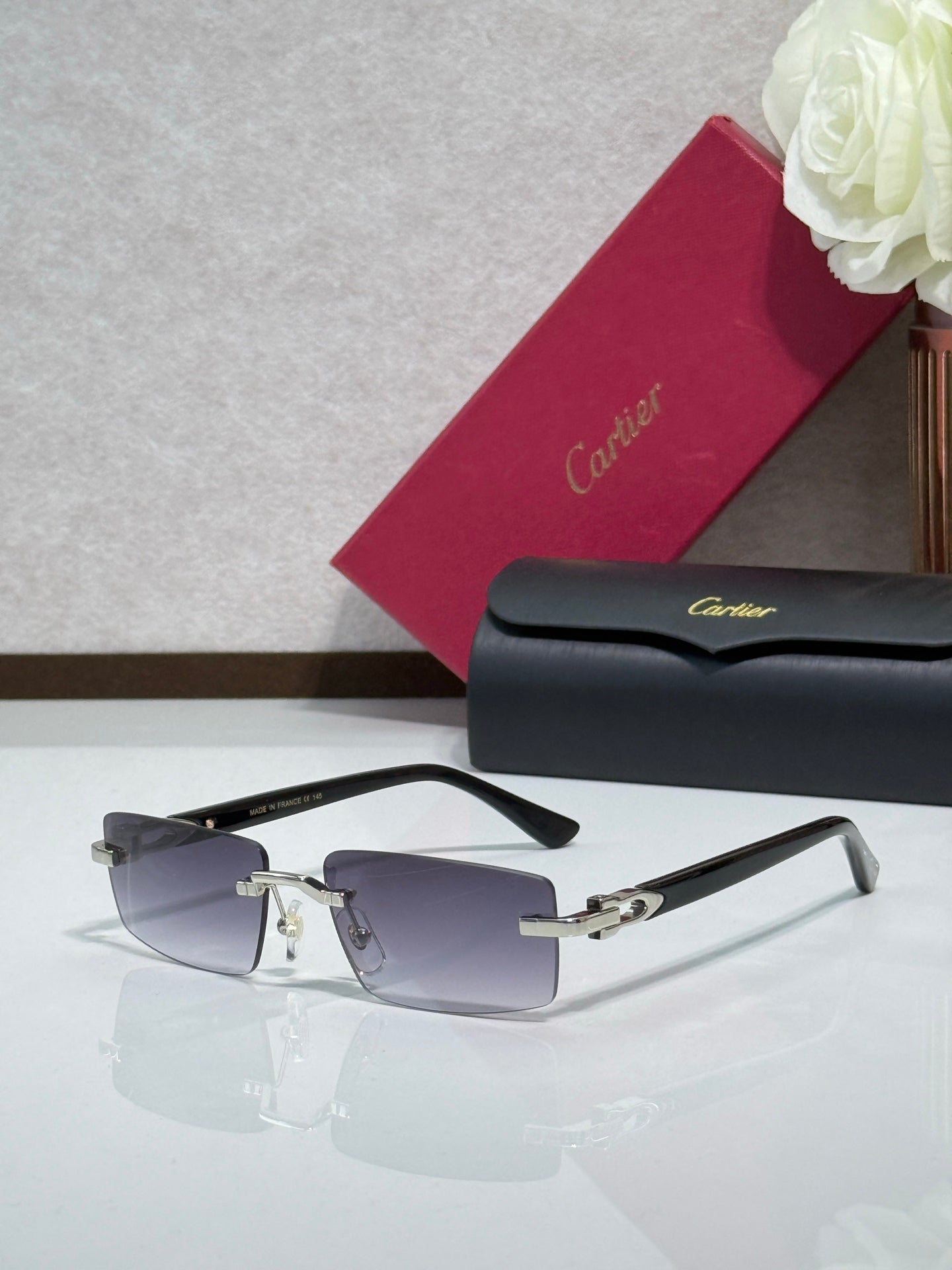 Cartier eyeglasses with dark frames and silver-tone hinges, featuring tinted lenses