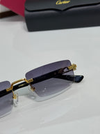 Cartier eyeglasses close-up with dark purple lenses and gold-tone bridge hardware