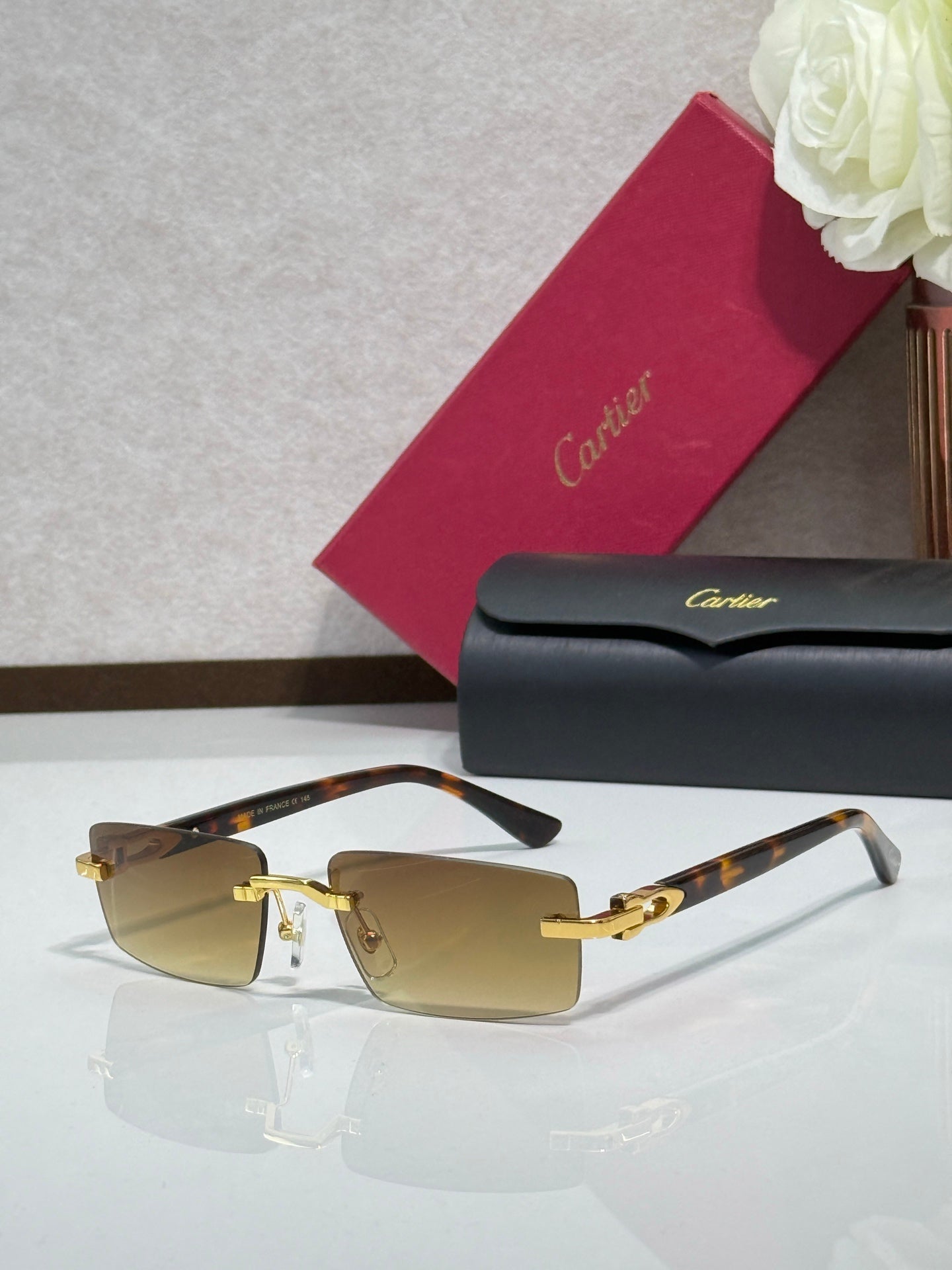 Cartier eyeglasses with gold-tone frame and amber-tinted lenses, clear temples