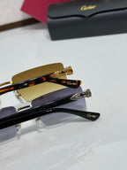 Cartier eyeglasses with tortoiseshell temples, gold-tone frame, and purple-tinted lenses