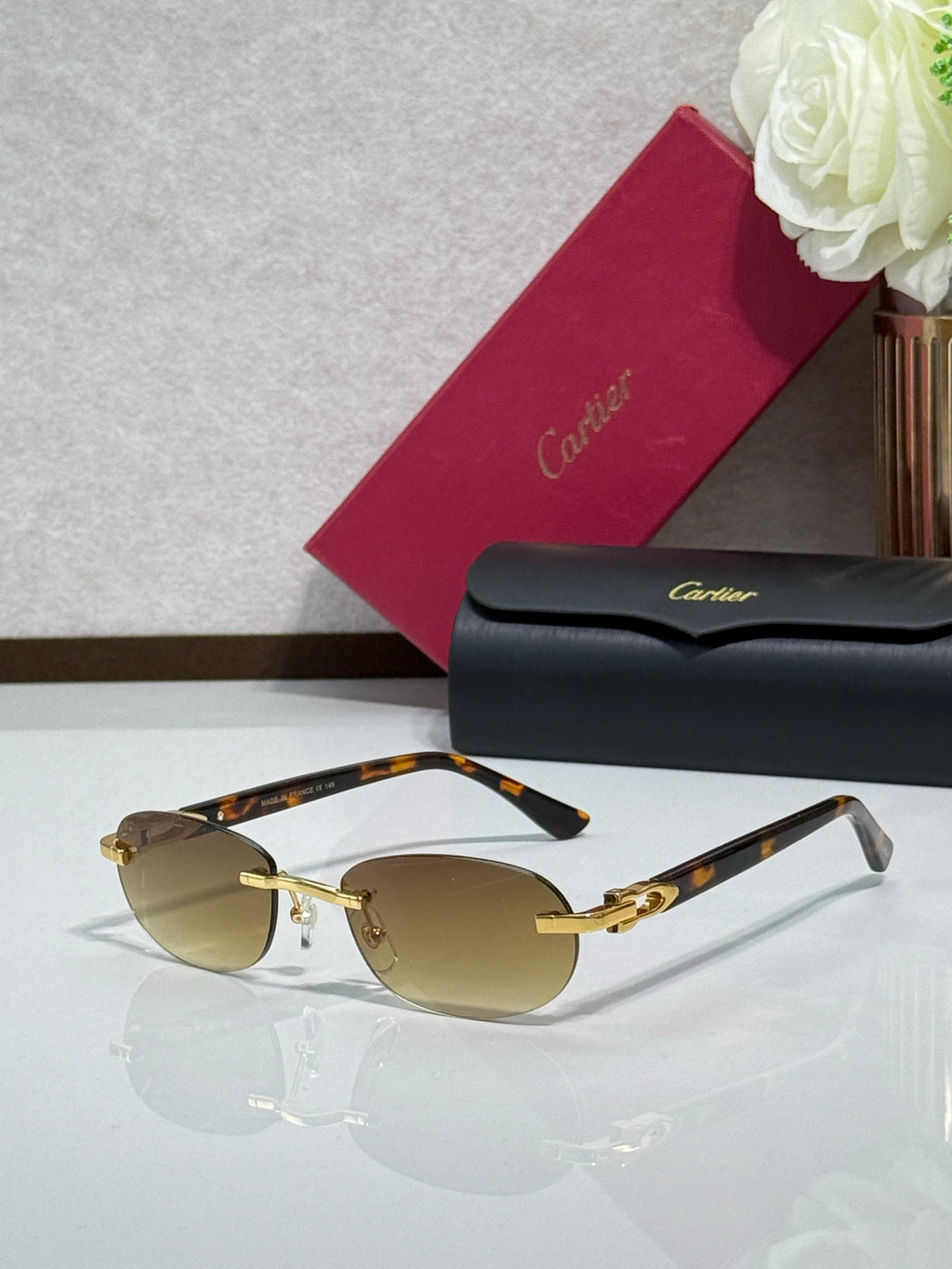 Cartier eyeglasses with amber lenses, gold details, and dark temple arms