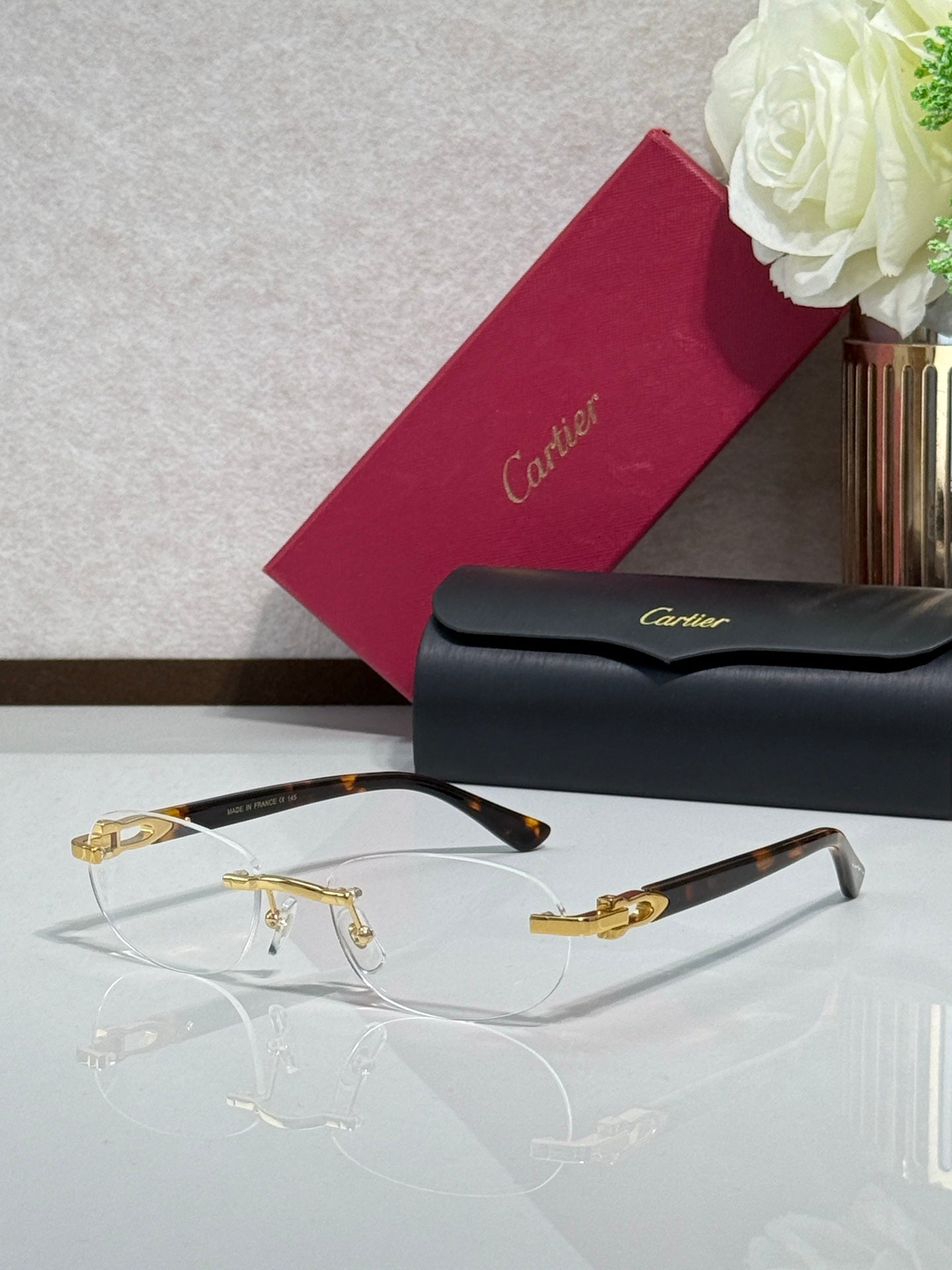 Cartier eyeglasses with clear lenses, gold frame accents, and dark temples