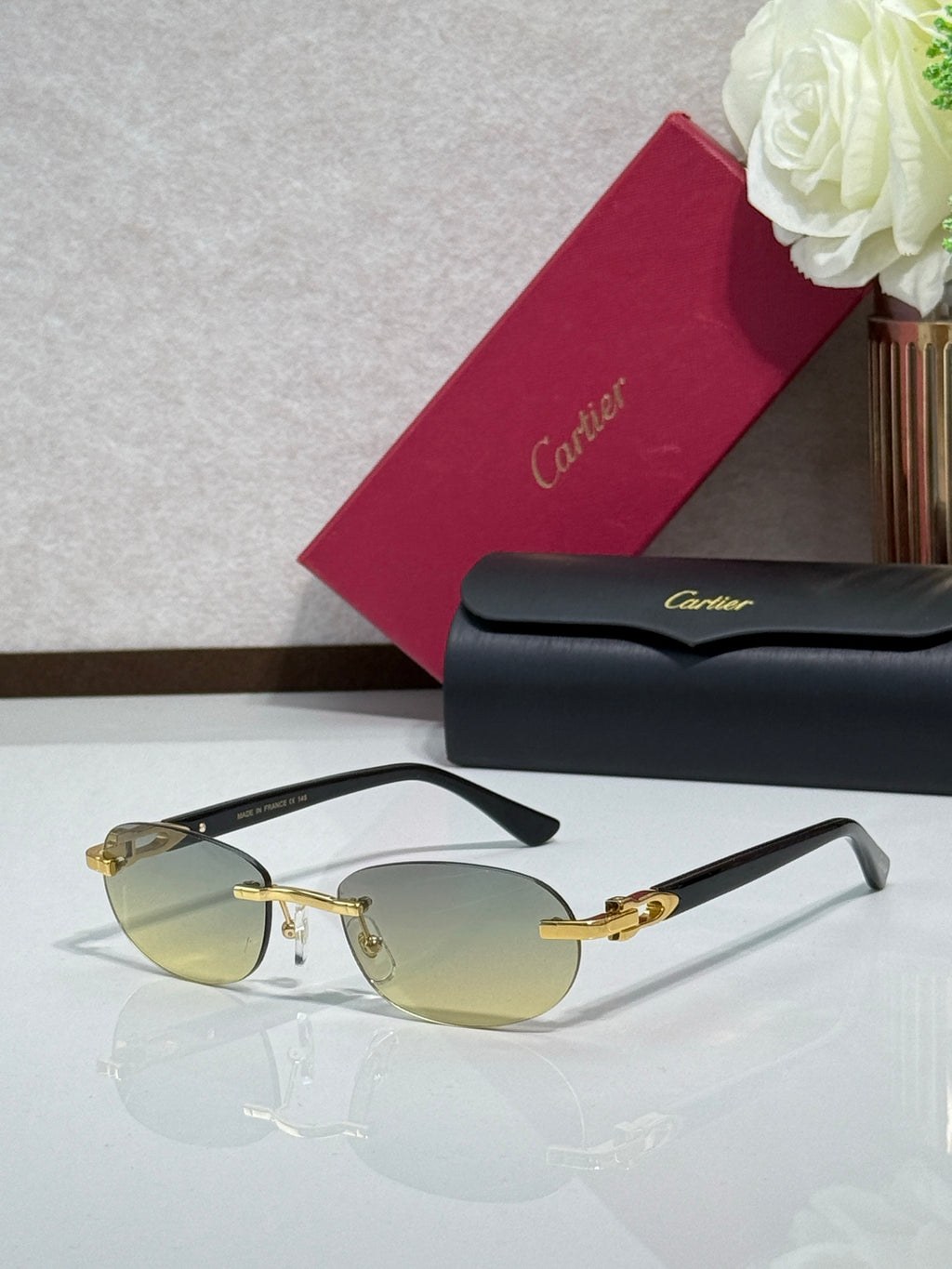 Cartier eyeglasses with pale yellow lenses, gold bridge, and dark temple arms