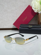 Cartier eyeglasses with pale yellow lenses, gold bridge, and dark temple arms