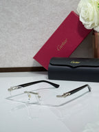Cartier eyeglasses with clear lenses and gold details on black temple arms