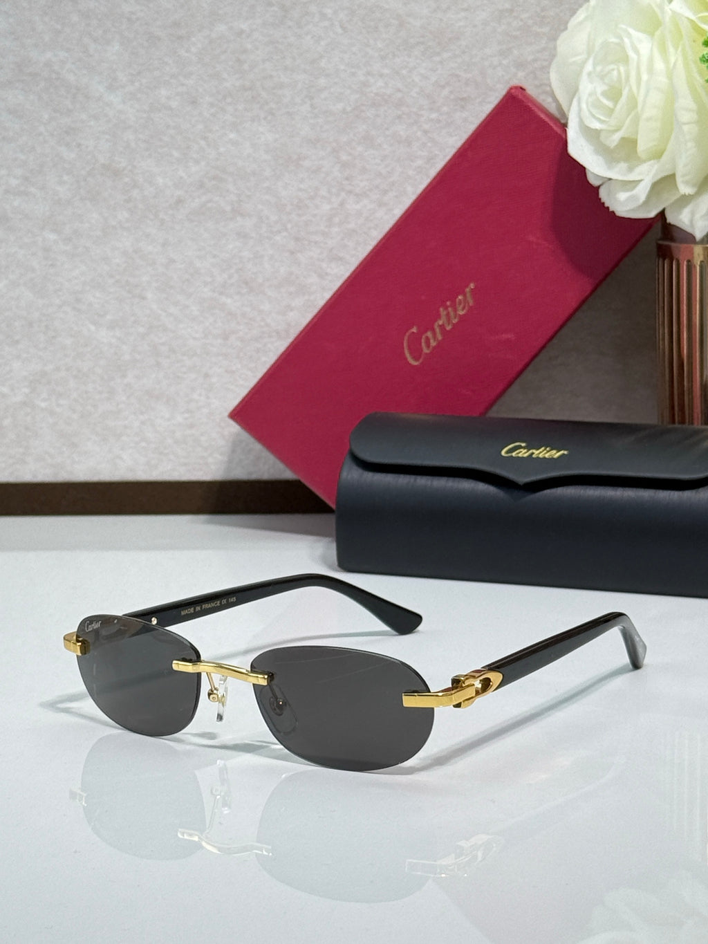 Cartier eyeglasses with dark gray lenses, gold frame accents, and dark temples