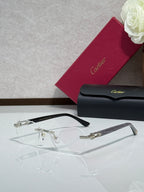 Cartier glasses with black frame, gold hinges, and clear eyeglass lenses