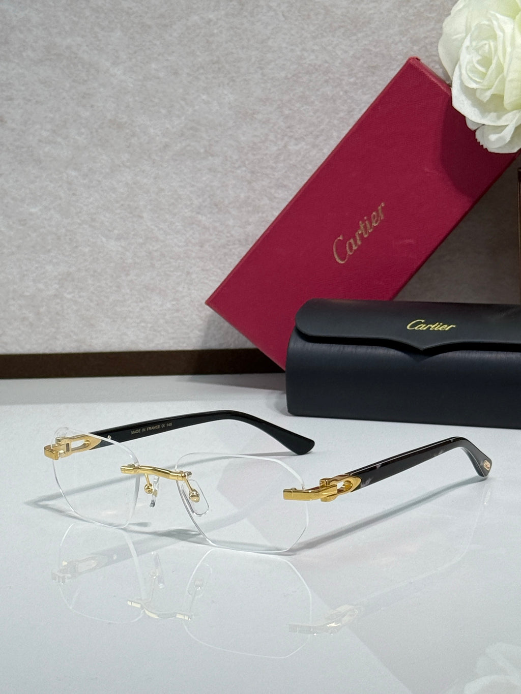 Cartier glasses with black frame, gold accents, and clear eyeglass lenses