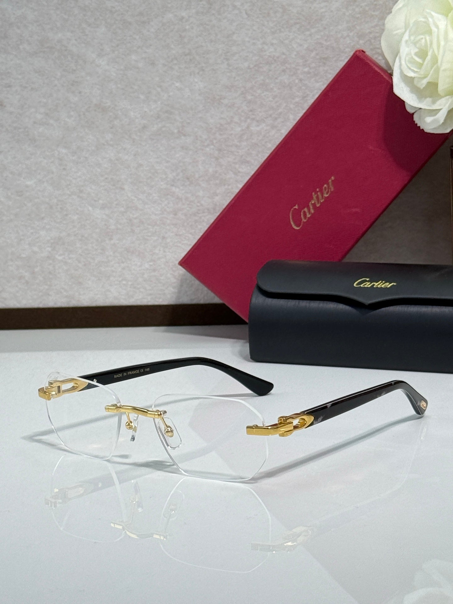 Cartier glasses with black frame, gold accents, and clear eyeglass lenses