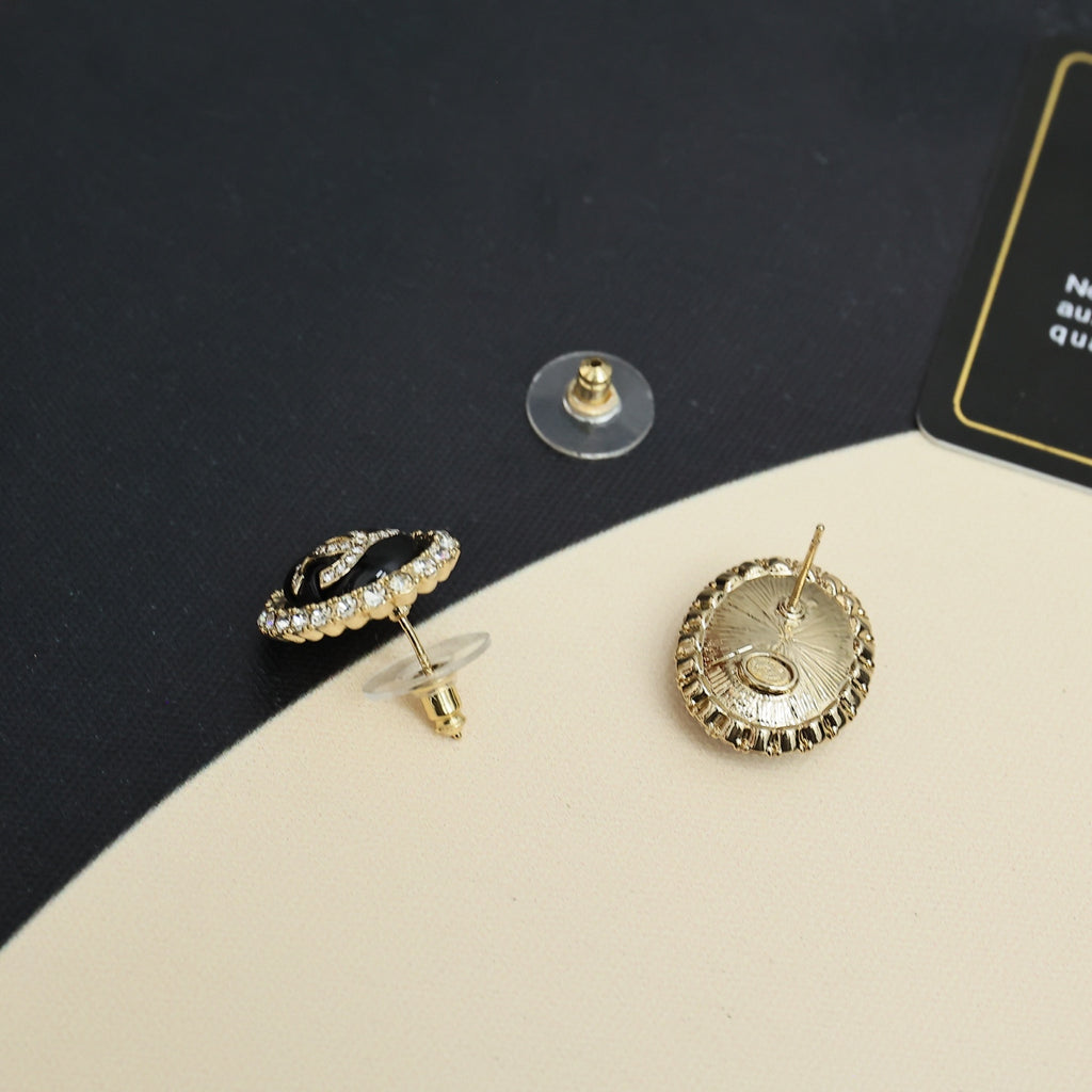 Chanel CC stud earrings with black-and-gold circular crystal edges and gold-tone posts